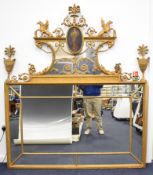 Regency multi panelled gilded mirror with ram's head, urn and swag decoration and portrait and
