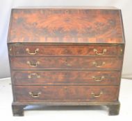Georgian flame mahogany bureau, fitted four graduated long drawers, the main fall flap opening to