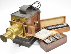 Brass and mahogany magic lantern converted to use with electricity, together with a collection of