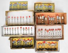 A collection of Dinky Toys British road signs and traffic bollards, grouped into sets.