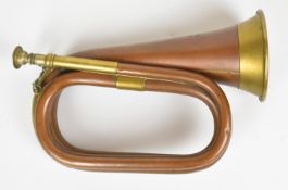 Copper and brass bugle inscribed Hawkes & Son, Denmark Street, Piccadilly Circus, London, 1917,