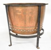 Riveted copper log bin on wrought iron stand, diameter 51, height 46cm