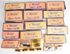Sixty carded Roco Minitanks and Eko HO scale military vehicles, the majority in original retailer