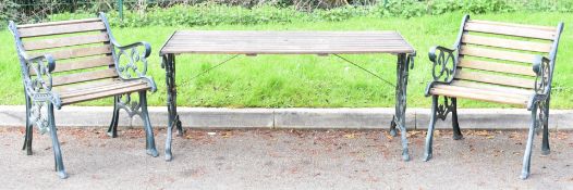 Cast metal and hardwood garden table and two chairs, the table L140 x D68 x H65cm