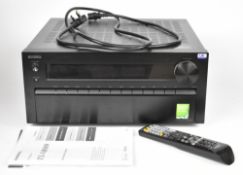 Onkyo TX-NR809 AV Receiver with remote control, user manual and power cable.