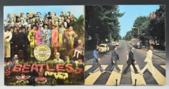 Two Beatles LPs comprising Sgt Pepper's Lonely Hearts Club Band and Abbey Road. Vinyl appears VG+ to
