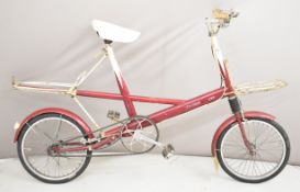 Moulton deluxe 4 speed bicycle with billiard cue style paintwork and front and rear racks, dated