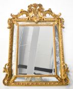 19thC giltwood bevelled and engraved cushion mirror with figural putti finial, W96 x H125cm