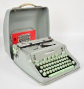 Hermes 3000 portable typewriter with original owner's manual and carry case.