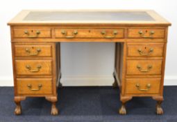 Victorian oak inset twin pedestal desk with an arrangement of eight drawers, raised on ball and claw