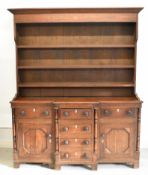 Georgian oak dresser with plate rack top, the base fitted six drawers and two cupboards with