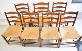Set of seven (6+1) Arts & Crafts oak rush seated dining chairs