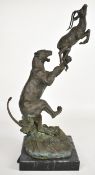 Bronze figure of a lioness capturing an antelope or gazelle in mid air, impressed signature 'Milo'
