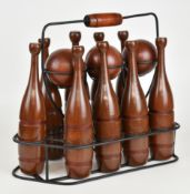 Turned wood lawn skittles set, housed in a metal carrier, height 31cm.