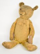 Early 20th century Teddy bear with straw filled body, disc jointed limbs and inoperable squeaker,