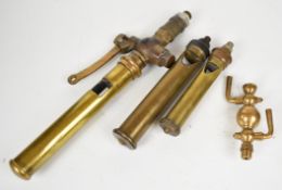 Three various whistles and an oil cup to suit live steam locomotive, traction engine or similar, the