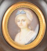 Georgian or Victorian portrait miniature on ivory of a lady with lace and blue bow head dress,
