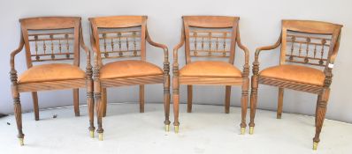 Set of four Regency carver dining chairs with reeded front legs and brass bases to the front legs