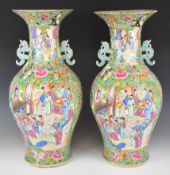 Pair of 19thC famille rose twin handled floor vases decorated with court scenes, butterflies,