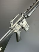 Unnamed 6mm blank plug firing M16 assault style rifle with composite stock pistol grip and forend