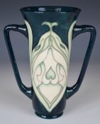Moorcroft twin handled vase / loving cup decorated in the Snowdrop pattern, MCC stamp to base,