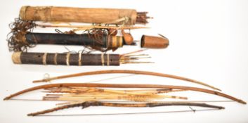 Three 19thC and later tribal quivers and three bows including African, fish arrows, tooled leather