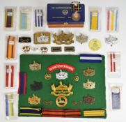 Small collection of Gloucestershire Regiment cap badges, insignia and a Gloucestershire Regiment