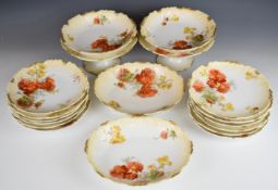 Limoges dinner and teaware decorated in orange and yellow floral pattern with scalloped rim,
