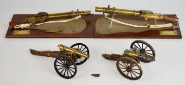 Four brass models of guns comprising two Lewis machine guns both mounted on wooden bases with