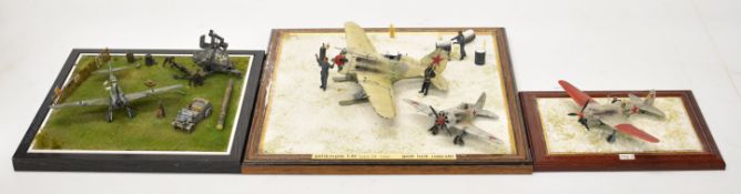 Three WW2 model dioramas comprising a 1/72 scale German Messerschmitt Bf-109 fighter plane on the