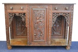 Anglo Indian carved cabinet with central cupboard and two drawers, W160 x D45 x H110cm