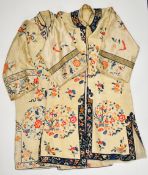 Two early 20thC Chinese cream silk tunics / coats embroidered with floral decoration, the largest