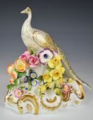 Crown Derby figure of a peacock with applied flower decoration, H18cm