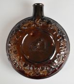 Rockingham circular flask relief decorated with a man drinking by an ale barrel, H20cm