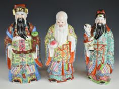 Three Chinese porcelain figures of Shou Lao and Fu, tallest 29cm