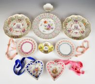 Three Dresden reticulated cabinet plates, a cup and saucer and four German ribbon plates / dishes,