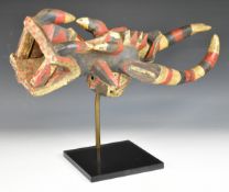 African tribal carved headdress on stand, probably Banda tribe, Guinea, length 63cm