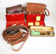 A collection of gun and shooting accessories including shotgun cartridge bags, two cartridge