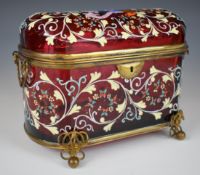 Cranberry glass twin handled casket with hinged domed lid, brass mounts and enamelled decoration,