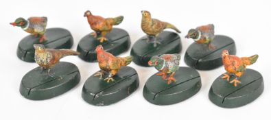 Eight cold painted bronze place card holders in the form of game birds, each approximately 2.8cm
