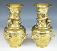 Pair of Chinese brass pedestal vases with relief moulded spiral decoration of a dragon chasing a