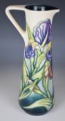 Moorcroft pedestal ewer decorated in the Iris pattern, with MCC mark and dated 96 to base, H24cm
