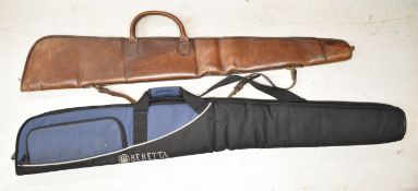 Two padded shotgun or rifle slips one Beretta Deluxe and one leather.