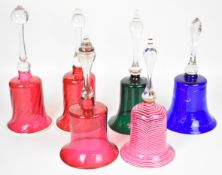 Six mainly 19thC glass bells including cranberry, blue, green and a Nailsea style example, tallest