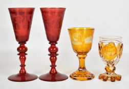 Two 19thC German cut and etched amber glasses with stag decoration, and a pair of oversized etched