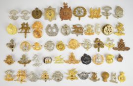 Approximately 50 cap badges and insignia including South Lancashire Regiment, Dorset Regiment, Royal
