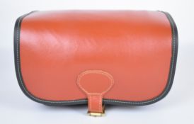 Brown leather shotgun cartridge loader's bag with shoulder strap, unused in original box.