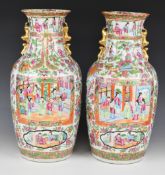 Pair of 19thC Chinese famille rose vases decorated with court scenes, H45cm