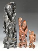 Three Chinese carved hardwood figures, one with bone teeth, tallest 55cm