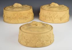 Three Wedgwood caneware game pie dishes with moulded decoration and hare finials, two with liners,